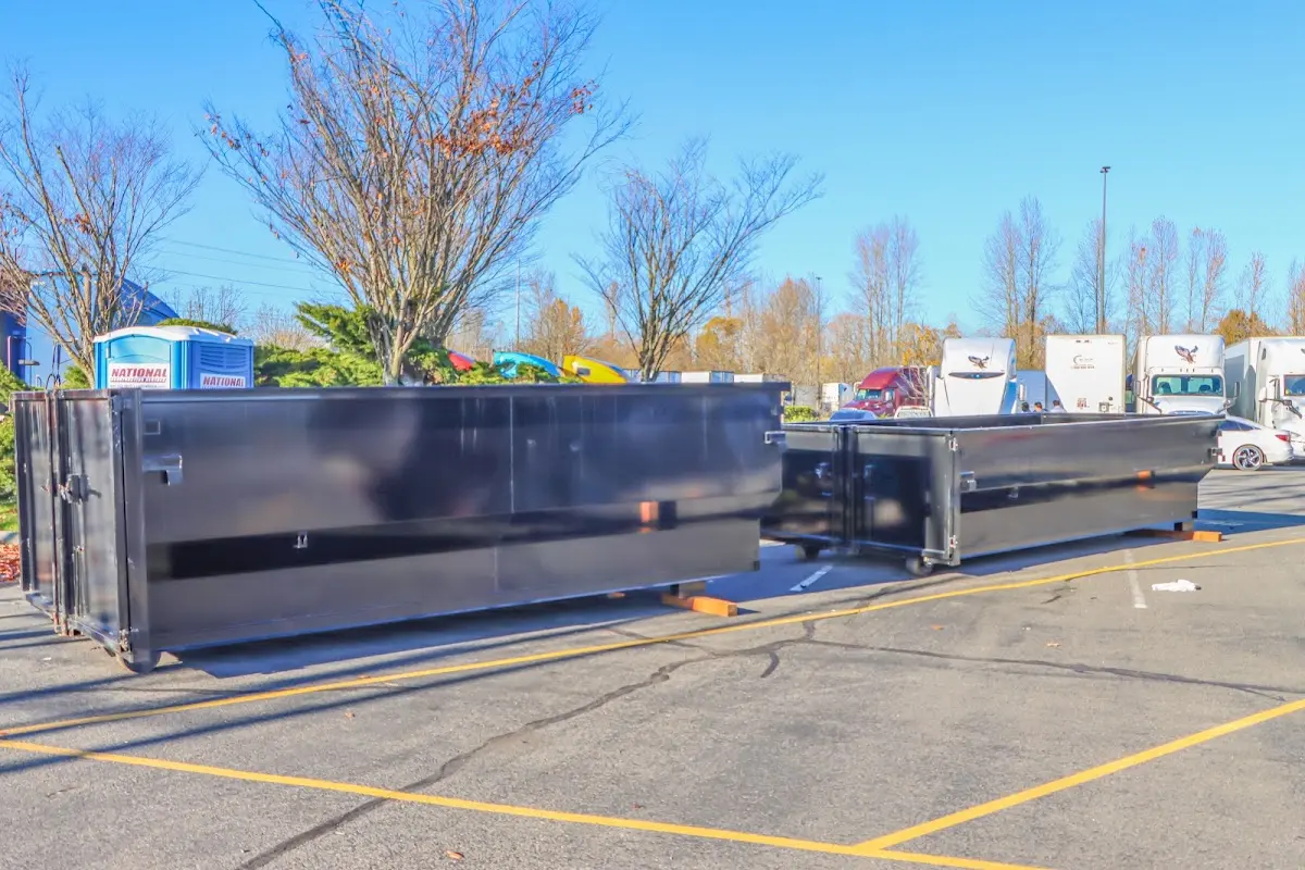 Professional dumpster rental service with roll-off container on residential driveway in Scottsbluff